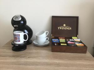 a table with a coffee maker and a coffee mug at Sunrise in Newhaven