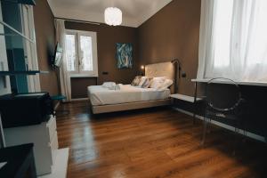 a bedroom with a bed and a television in it at Villa Calipso in Mondello