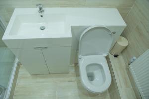a bathroom with a white toilet and a sink at Inviting 1-Bed House in Bradford in Bradford +28 photos