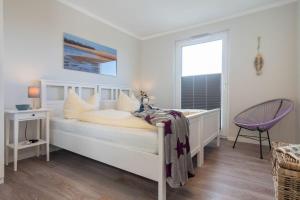Ein Bett oder Betten in einem Zimmer der Unterkunft Apartmenthaus "Kiki", Wohnung "Traumbude"