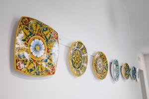 a group of plates hanging on a wall at Villa Calipso in Mondello