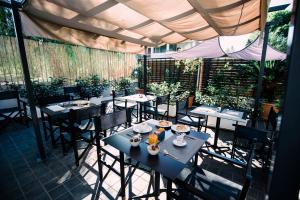 a restaurant with tables and chairs on a patio at Villa Calipso in Mondello