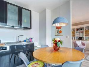 a kitchen with a table with a vase of flowers on it at Haffkieker in Zirchow +13 photos