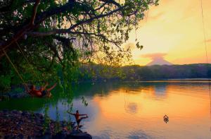 a group of people in the water at sunset at El Pital, Chocolate Paradise in Balgue +92 photos
