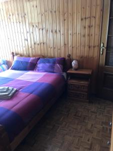 La Casa del Don في سان-رهيمي-أون-بوسيز: غرفة نوم بسرير وجدار خشبي