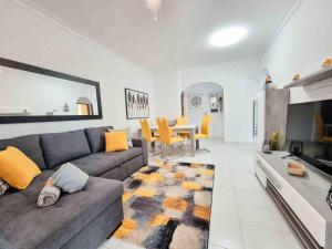 a living room with a couch and a dining room at Apartment Praia Rocha Candimar Sunflower in Portimão
