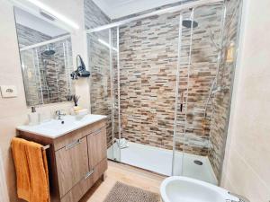 a bathroom with a sink and a glass shower at Apartment Praia Rocha Candimar Sunflower in Portimão +37 photos