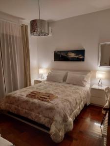 a bedroom with a bed with two lamps and a chandelier at Olympic Suite Roma in Rome