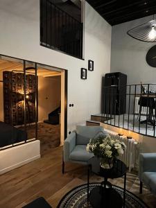 a living room with a couch and a table at Entre Nous Le Du Bellay in Saumur