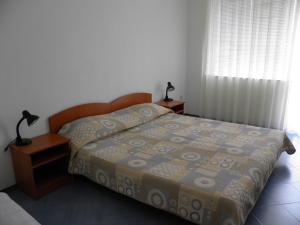 A bed or beds in a room at Family Hotel Maritime