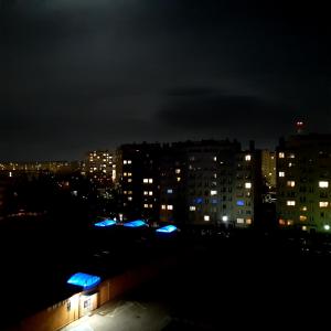 a city lit up at night with buildings at Apartament Hetmańska in Wałbrzych