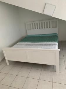 a white bed sitting in a room with at 3 Room Apartment in Wiesbaden in Wiesbaden
