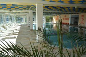 a resort with chairs and a swimming pool at Allgäu Ankerplatz mit Sauna und Pool in Scheidegg