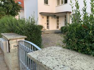 ein weißes Haus mit einem Tor und einem Zaun in der Unterkunft 3 Room Apartment in Wiesbaden in Wiesbaden
