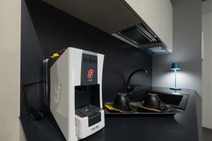 a kitchen with a coffee machine on a counter at BBCUBE in Porto Viro