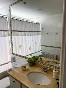a bathroom with a sink and a toilet and a mirror at Unique GolfLodge in Santo Domingo +58 photos