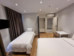 a hotel room with two beds and a bathroom at 10m2 Hotel in Istanbul