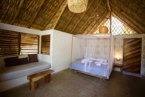 a bedroom with a bed and a canopy at El Pital, Chocolate Paradise in Balgue