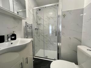 a bathroom with a shower and a sink and a toilet at Oxford Street Stays in Southampton