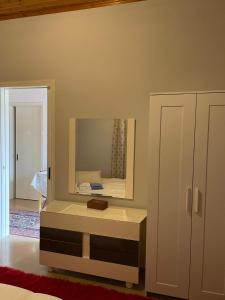 ein Schlafzimmer mit einem Spiegel und einem Bett darin in der Unterkunft Villa Lochia in Rámia
