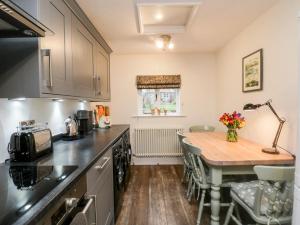 a kitchen with a wooden table and a counter top at 29 Bondgate in York