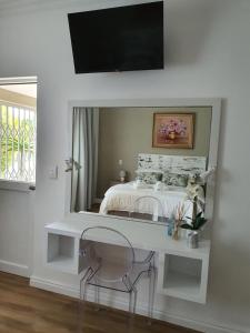 a white desk with a mirror in a bedroom at Plett57 - Self Catering - Room No2 in Plettenberg Bay