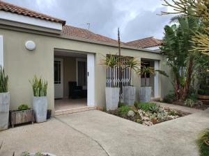 a house with a courtyard with plants in it at Plett57 - Self Catering - Room No2 in Plettenberg Bay