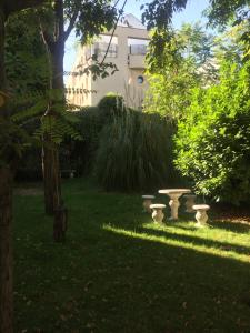 a garden with a stone bench in the grass at Apartamento Arturo Soria in Madrid