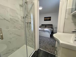 a bathroom with a shower and a sink at Oxford Street Stays in Southampton