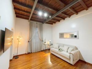 a living room with a white couch and a window at Pantheon Grand Suite in Rome