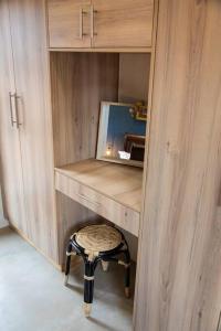 a dressing room with a stool and a mirror at Wildheart Safari - Lion's Den in Hoedspruit