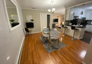 a dining room and living room with a table and chairs at A Modern Apt close to downtown in Lancaster