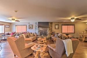 a living room with couches and chairs and a fireplace at Modern Deadwood Apt with RV Parking and Views! in Deadwood