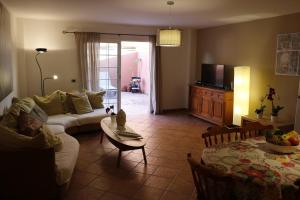 a living room with a couch and a table at Family and Friends , Familienapartment Playa de San Juan in Guía de Isora