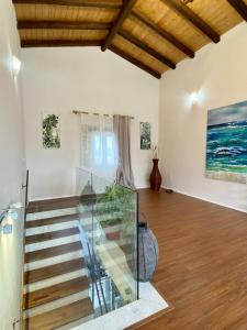a staircase in a living room with wooden ceilings at Tani's House in Sarandë +43 photos