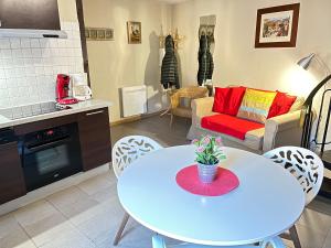 a kitchen and living room with a table and a couch at Gite St Léon à Eguisheim in Eguisheim