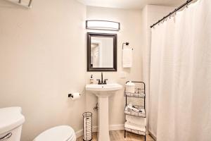 a bathroom with a sink and a toilet and a mirror at Geodesic Dome House with Scenic Views and Hot Tub in Eatonville +23 photos