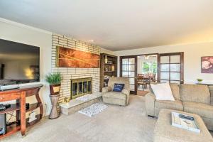 a living room with a couch and a fireplace at Spacious Tacoma Getaway 2 Mi to Old Town! in Tacoma