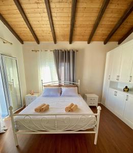 a bedroom with a bed with two towels on it at Tani's House in Sarandë