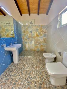 a bathroom with two toilets and a sink at Tani's House in Sarandë