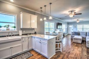 a kitchen with a sink and a living room at Ocean Isle Beach Escape - Centrally Located! in Ocean Isle Beach