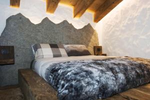 a bedroom with a large bed with a wolf headboard at AL BAIT DA LUCIA Bormio in Bormio