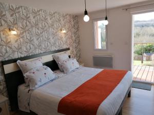 a bedroom with a large bed and a window at Les Terrasses du Ris in Douarnenez