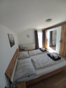 duże łóżko w sypialni z oknem w obiekcie Appartement Müllner w mieście Kirchdorf in Tirol