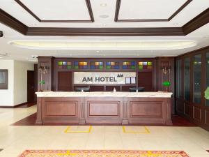 a hotel lobby with a am hotel sign on the wall at AM Hotel in Singapore