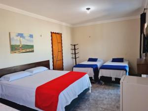 A bed or beds in a room at Hotel Camocim