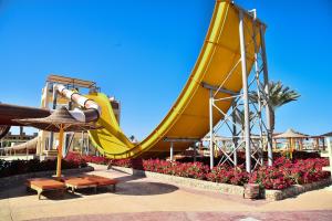 a yellow slide at a water park at Apartements at karma beach hotel & aqua park in Hurghada