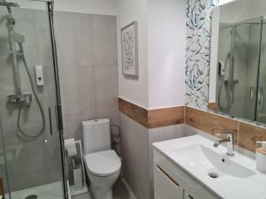 y baño con aseo, lavabo y ducha. en Apartament Wyszyńskiego 10, en Białystok