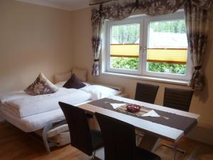 a dining room with a table and a window at Apart Alblittblick in Kappl