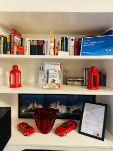 a book shelf with two toy cars and books at Casa Giorgia luxury apartment in Rome
